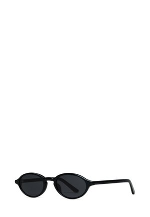 Black sunglasses with oval lenses and thin, sleek plastic frames. The lenses are dark, and the frames feature a unique, rounded design.