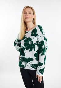 Groen bloemmotief op een lichtgrijze gebreide trui met een ronde halslijn en lange mouwen, gemaakt van zachte wolmixstof.