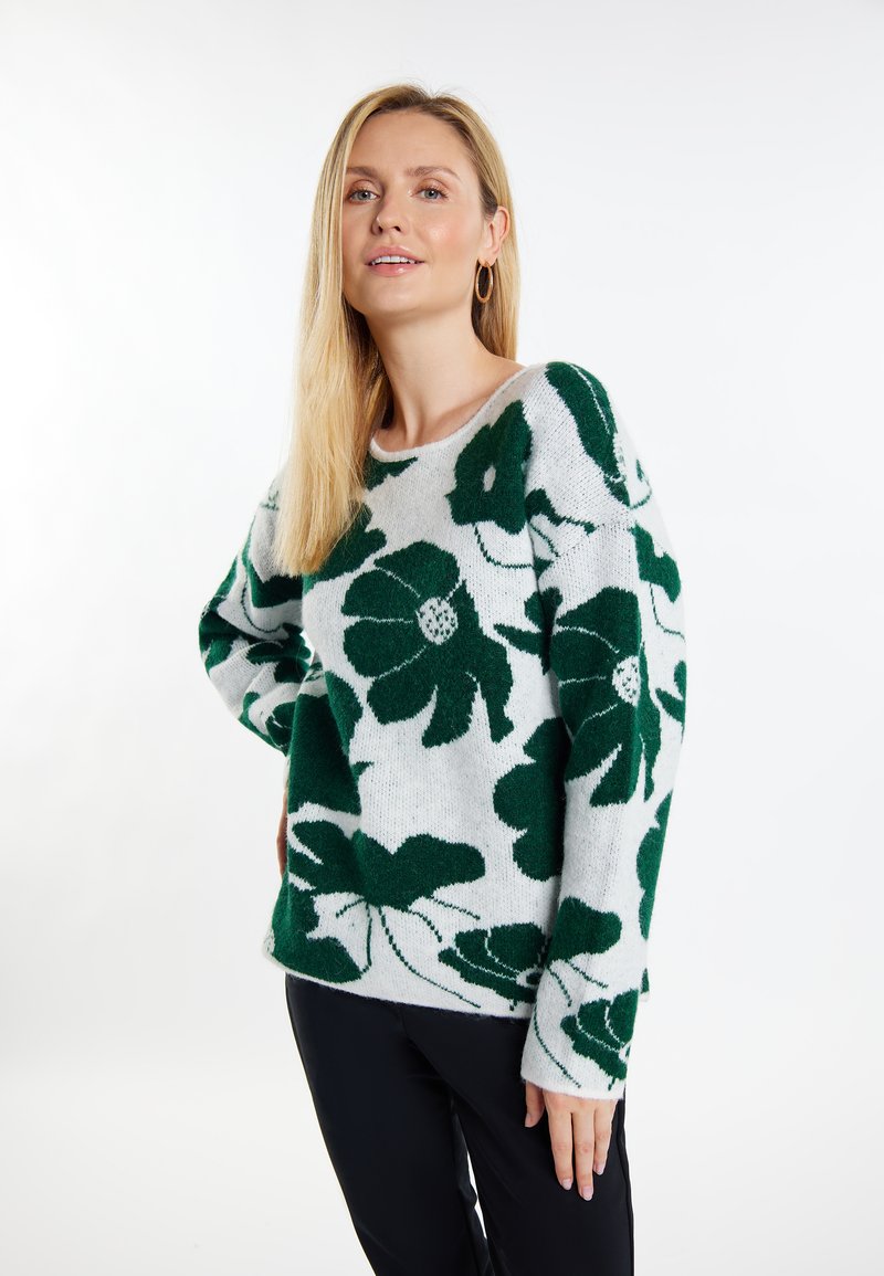 Groen bloemmotief op een lichtgrijze gebreide trui met een ronde halslijn en lange mouwen, gemaakt van zachte wolmixstof.