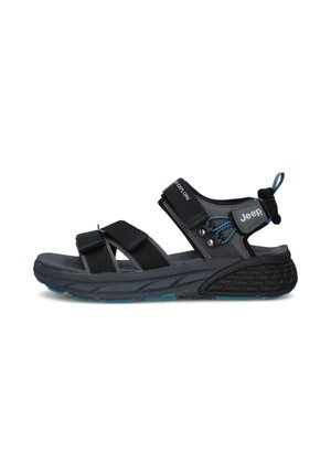 Sandalia deportiva exterior de la marca Jeep en negro y gris para hombre, con tiras ajustables y suela gruesa y texturizada.