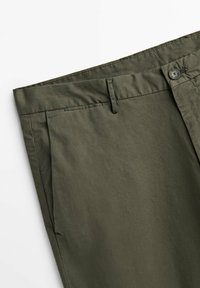 Pantaloni verde oliva realizzati in tessuto leggero, con frontale piatto, due tasche laterali e chiusura con bottone in vita.