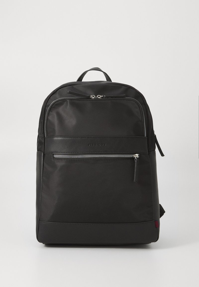 Black fabric backpack with a smooth texture, featuring a top handle, adjustable straps, and a front zip pocket with silver hardware.