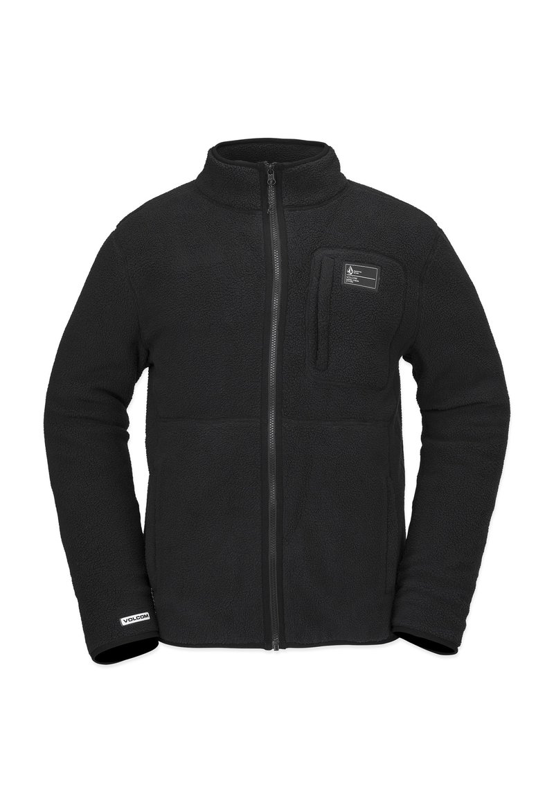 Chaqueta de forro polar negra con cierre delantero, cuello alto y un bolsillo en el pecho. Presenta una textura suave y una etiqueta de logo cerca del dobladillo.
