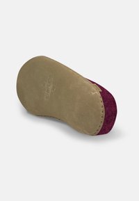 Suede slipper sole with a burgundy upper and beige leather outsole. Features stitched detailing and a rounded shape for comfort.