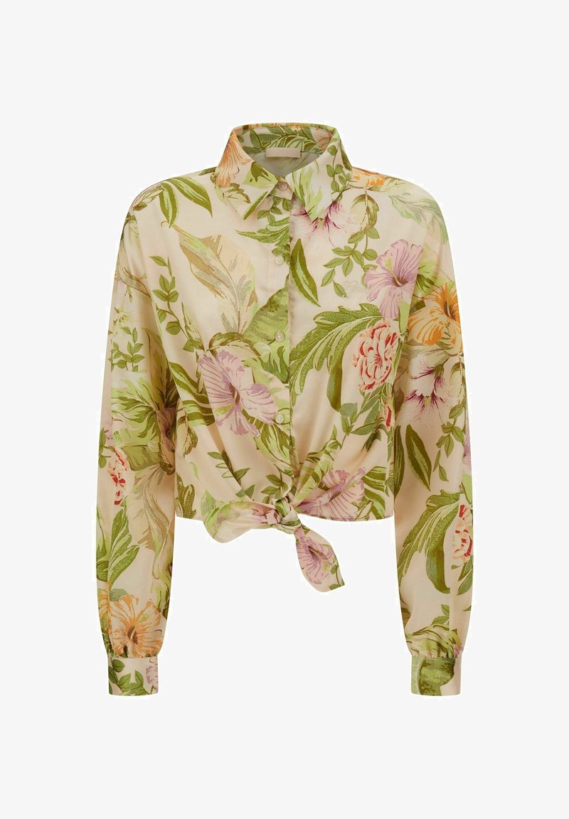 Chemise courte à imprimé floral en tissu léger, présentant des fleurs vertes, roses et orange sur un fond beige clair, avec un détail noué à l'avant.