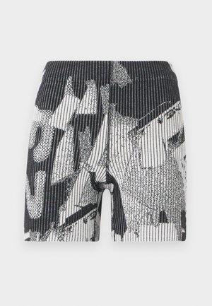 Pantalones cortos de patrón en blanco y negro con una textura acanalada. El diseño presenta formas abstractas y rayas. Cintura elástica para un ajuste ajustado.
