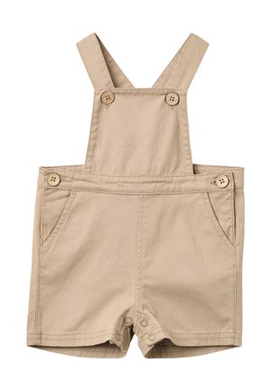 Beige Baumwoll-Strampler für Kleinkinder mit Knöpfen an Trägern und Seiten, vorderen Taschen und Druckknöpfen im Schritt.
