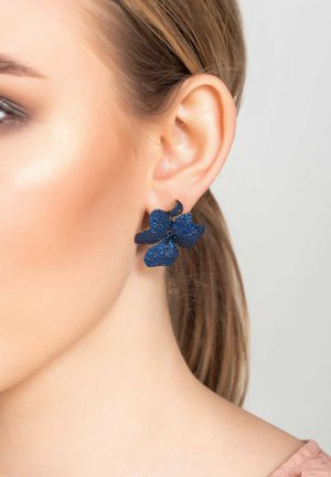 Blue flower-shaped earrings with textured surfaces and gold accents, secured with a standard earring backing.