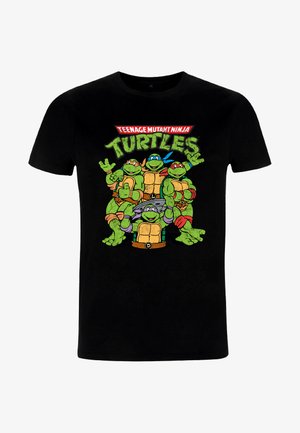 Black cotton t-shirt featuring vibrant, cartoon-style graphics of four green turtles, wearing colored masks and posing, with text above.