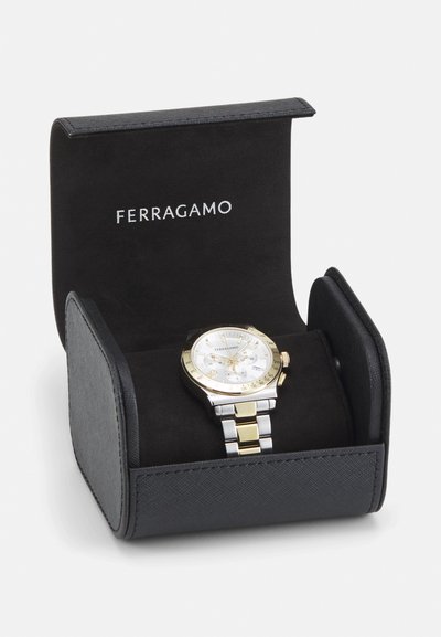 Ferragamo watch in a black case with suede lining. Watch features a silver and gold stainless steel band, white dial, and gold accents.
