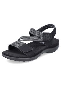 Sandalia negra con dos correas elásticas anchas y una superficie texturizada. Presenta una suela moldeada con un ligero tacón, adecuada para el uso casual.