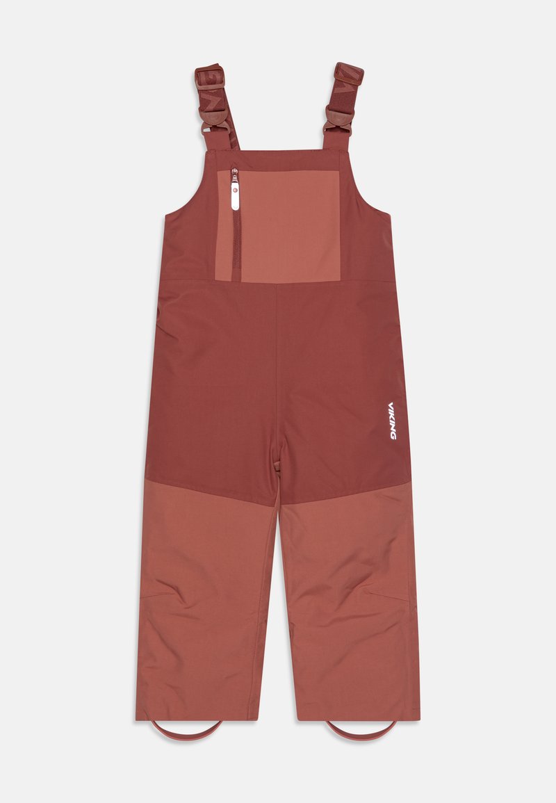 Nepremokavé hnedé overal nohavice s nastaviteľnými popruhmi, zipsovou hrudnou vreckom a kontrastným farebným blokovým dizajnom. Obsahuje slučky na členkoch.