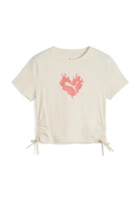 Camiseta corta de color crema con mangas cortas, presenta un gráfico de corazón en llamas rosa y detalles laterales con cordones para un ajuste ajustable.