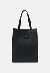Sac fourre-tout noir en cuir lisse, avec deux poignées courtes, un détail de logo ovale et un design minimaliste sans fermetures visibles.