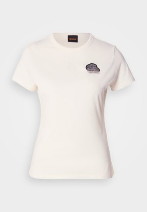 White cotton t-shirt with a round neck and short sleeves. Features a black embroidered cloud design with fringe detail on the chest.