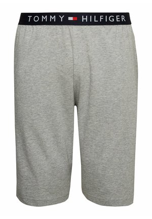 Grijze katoenen shorts met een elastische zwarte tailleband met "TOMMY HILFIGER" in witte letters. Gladde textuur en knielange uitstraling.
