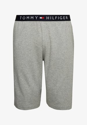 Graue Baumwollshorts mit einem elastischen schwarzen Bund, der "TOMMY HILFIGER" in weißer Schrift trägt. Glatte Textur und knielanges Design.