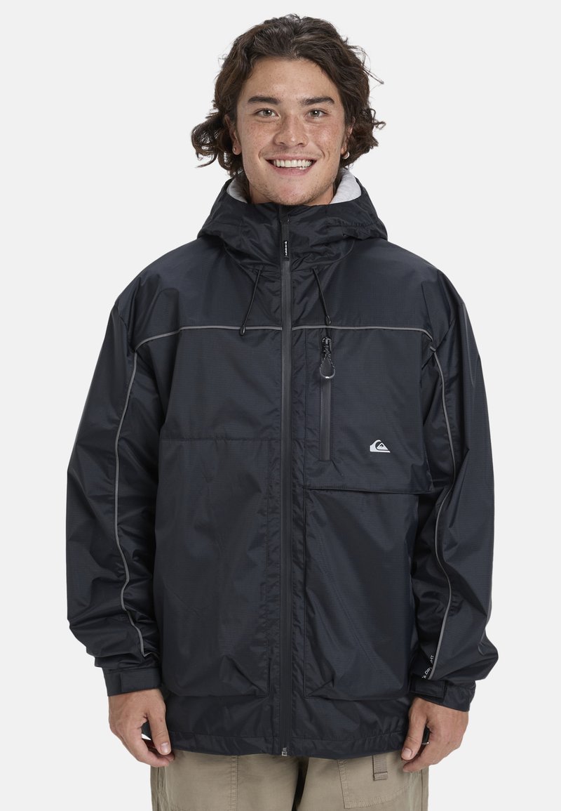 Black jacket made of lightweight, water-resistant material. Features a hood, chest pocket, and reflective accents along the seams.
