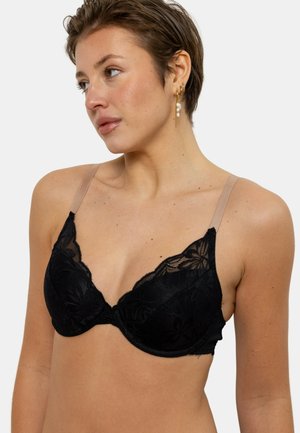 Soutien-gorge en dentelle noire à décolleté plongeant, avec des bretelles nues transparentes. Contient des motifs floraux et un soutien-gorge avec armature pour maintenir la forme.