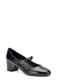 Zapato Mary Jane de cuero negro con tacón cuadrado plano, punta redonda y correa ajustable con hebilla de plata. Textura suave, diseño clásico.