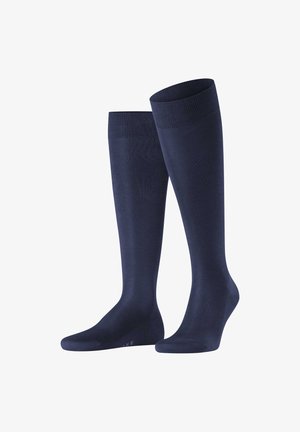 Granatowe skarpetki do kolan wykonane z gładkiego, elastycznego materiału, z żebrowanym wykończeniem na górze i bezszwowym fasonem na stopie. Odpowiednie na różne okazje.