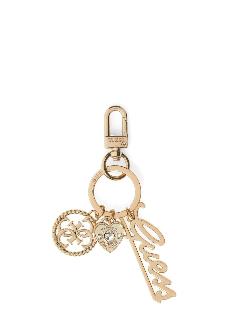 Gold-tone metal keychain with "Guess" script charm, heart charm with rhinestones, and a circular logo charm on a lobster clasp.