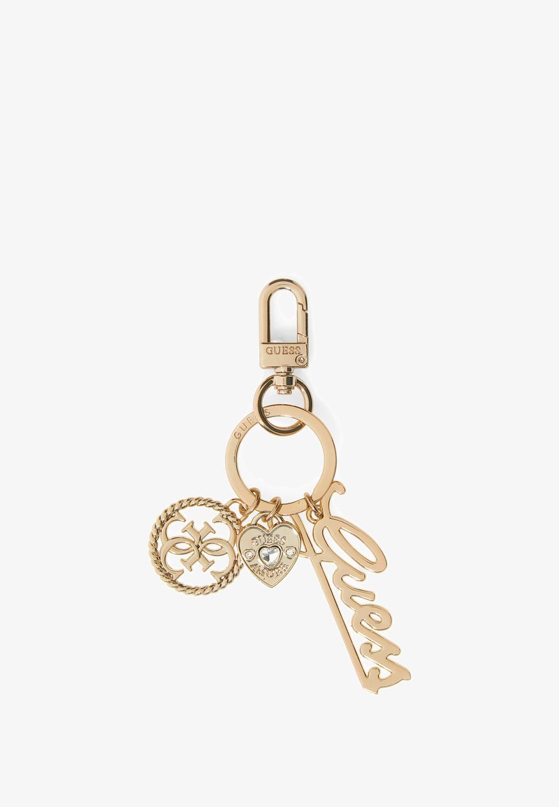 Gold-tone metal keychain with "Guess" script charm, heart charm with rhinestones, and a circular logo charm on a lobster clasp.