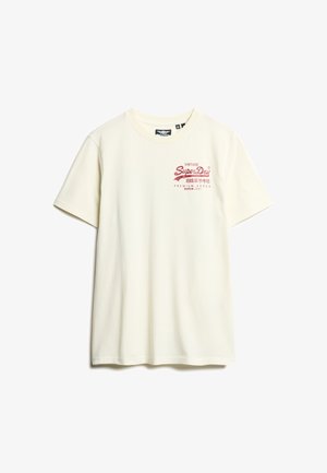 Jasno kremowy bawełniany t-shirt z krótkimi rękawami. Na przodzie znajduje się czerwony nadruk z napisem "Vintage Super-Dry". Klasyczny okrągły dekolt.