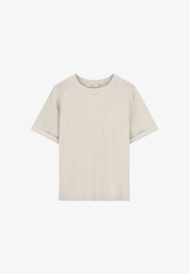 T-shirt en coton beige clair avec des manches courtes, un col rond et des revers aux manches. Texture lisse, sans motifs ni accents visibles.