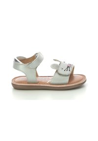 Silver leather sandals with dual adjustable straps, flat brown sole, and embroidered animal design on the toe strap.