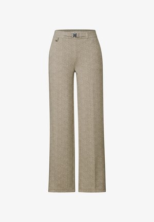 Pantalons larges beiges en tissu texturé. Dotés d'une ceinture avec boucle en argent et d'une poche latérale discrète. Design épuré et ajusté.