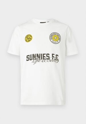 White cotton T-shirt with short sleeves. Features two circular patches, one yellow and one black, and black text "SUNNIES FC" and "Lyle & Scott."