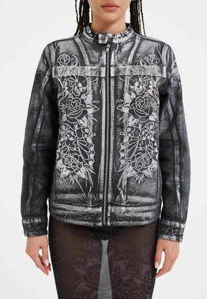 Black denim jacket featuring gray floral and skull embroidery, front zipper, stand collar, and two side pockets. Smooth, textured fabric.