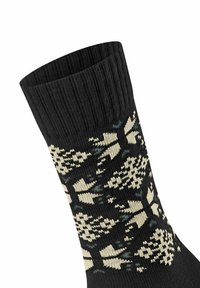 Calzino nero lavorato a maglia con polsino a coste testurizzato e motivo floreale crema. Materiale morbido con forme distinte e colori a contrasto.