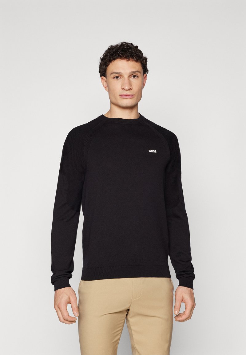 Schwarzer Strickpullover mit rundem Halsausschnitt und gerippten Bündchen. Mit einem kleinen weißen "BOSS"-Logo auf der Brust und strukturierten Schulterakzenten.