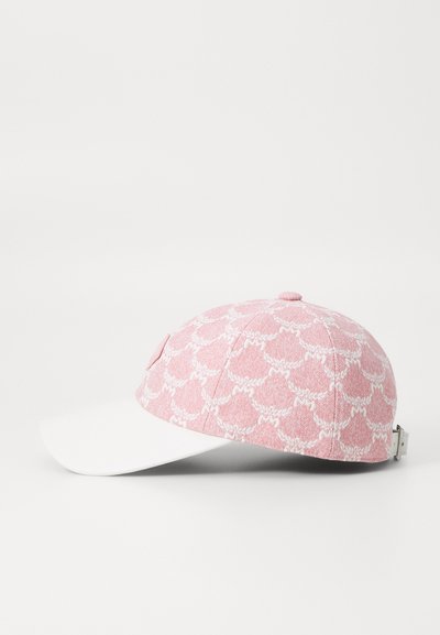 Cap features a pink patterned fabric with white accents, a solid white brim, and a metallic clasp on the back for adjustment.