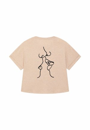 T-shirt beige a maniche corte con un disegno a linee nere sul retro. Tessuto morbido, vestibilità rilassata e scollo rotondo.