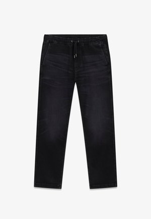 Zwarte spijkerbroek met een elastische tailleband en trekkoord. Voorzien van twee steekzakken aan de zijkant en een rechte pijp. Soepele textuur.