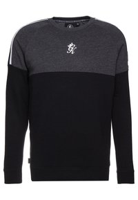 Felpa nera e grigia con scollo rotondo, maniche raglan e un logo bianco sul petto. Presenta un design a blocchi di colore.