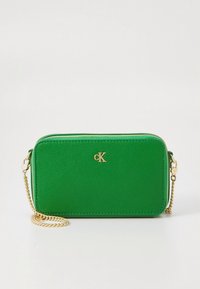 Green faux leather crossbody bag with gold chain strap, rectangular shape, zip closure, and embossed logo on the front.