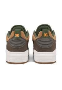 DC sneakers featuring a brown suede and mesh upper, with green accents and a white rubber sole. Logo in orange on the heel.