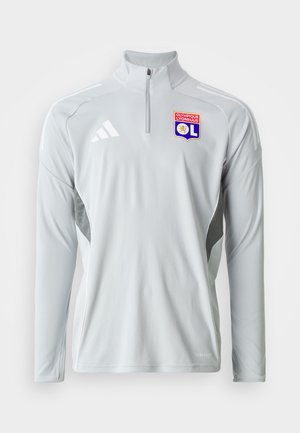 Pullover sportif à manches longues de couleur gris clair avec un col zippé à mi-hauteur, présentant des accents blancs sur les côtés et un logo brodé de l'Olympique Lyonnais.
