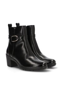 Botines de cuero negro hasta el tobillo con tacón cuadrado, que cuentan con un detalle de hebilla lateral, textura suave y dos asas en el cuello.