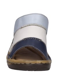 Slip-on sandals featuring a mix of blue, white, and navy leather. Open toe design with a slight curve in the strap and textured brown sole.