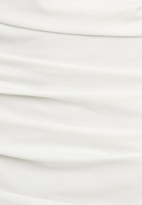 White fabric with a gathered texture, showcasing soft folds and a smooth surface. The material appears lightweight and flowy.