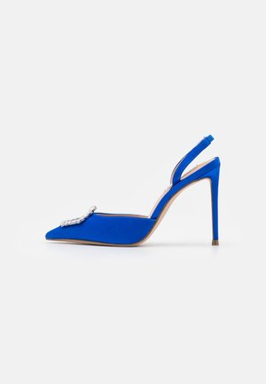 Blue satin high-heeled slingback shoe with pointed toe and a decorative silver crystal buckle on the front.