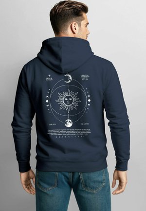 Navy hoodie with a drawstring, features a sun and moon graphic in white on the back, accompanied by text. Made from soft fabric, casual fit.