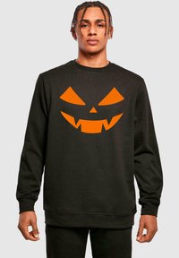 Felpa nera con un grande design di faccia di zucca arancione con denti frastagliati; polsini e orlo a coste.