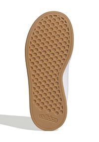 Adidas-Sohlen mit einem Wabenmuster aus Gummi, mit einem glatten weißen oberen Rand. Der Text "adidas" ist an der Seite geprägt.