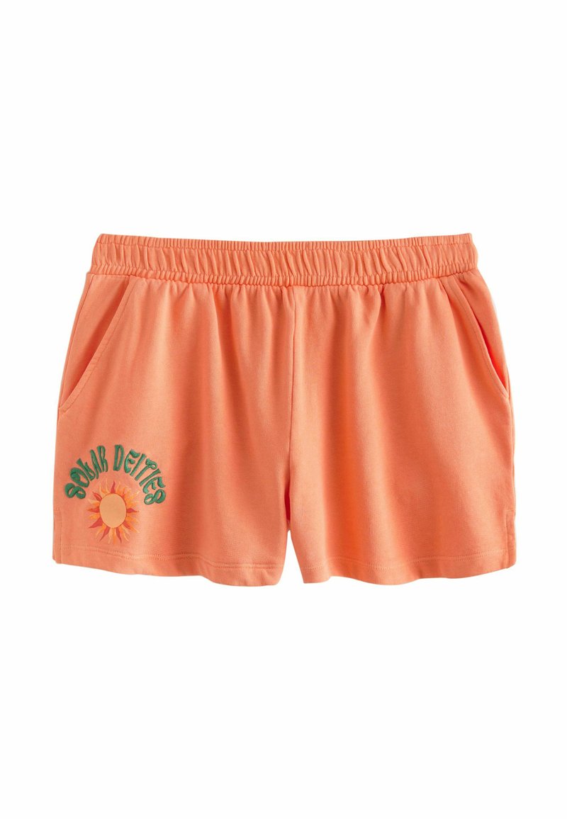 Oranga bomullsshorts med resårmidja, två sidofickor och en solgrafik med "Solar Deities" broderat i grönt.